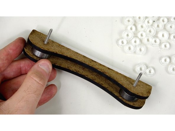 Do the same thing on this side. Bushing, bearing, bushing. One on each bolt.