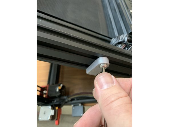 Using one of the extra M5x12mm screws that came with your CR30 fasten the 3D printed safety bracket to the slide nut you just inserted. Leave it facing down for now so its out of the way. You can lock it in place later once its on the wall. Re fasten the crossmember screw you had to remove in the previous step.