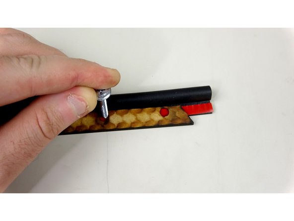 Use a sharp object to mark the P Gasket where the holes are in the seal bar. You can use one of the screws that came in the kit (Pic 2), or a sharpie/pen.