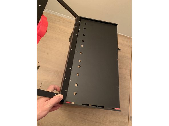 Bend the tops of the sidepanels out slightly to allow the top panel and lid assembly to fall into place and press their tennons into the corresponding cuts at the top of each sidepanel