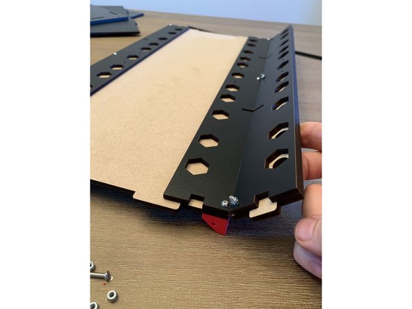 When assembled correctly the front exit panel should fold upward and stop at about a 45 degree angle from the base panel.