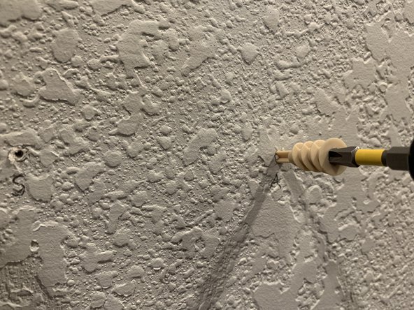 For the marked holes where there is no stud we'll want to set a drywall anchor. The best way to do that is to pre drill a hole slightly smaller than the anchor and slowly drive the anchor into the drywall using a Phillips or flat head screwdriver.