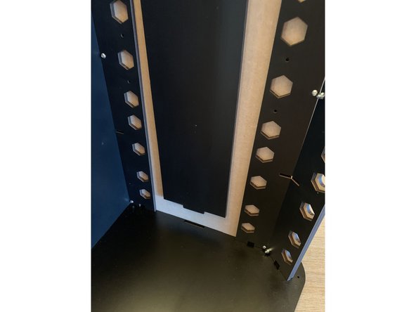 Run a 16mm screw through from the backside of the side panel to affix the bracket. Repeat this process MIRRORED for the other side.