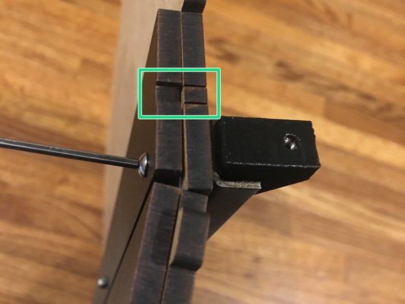 Place one of the prepared L brackets inside of the steel support beam facing outward. Secure it in place using one of the 16mm bolts. Insert the bolt from the opposite end so it catches the square nut in the bracket.