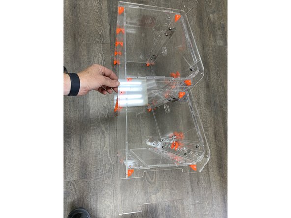 Once your RepBoxes are assembled, lay them on their sides as pictured and remove the four screws that hold the side panel on BUT DO NOT REMOVE THE SIDE PANELS.