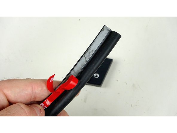 Pull back a short portion of the protective film from the adhesive of the P Gasket.