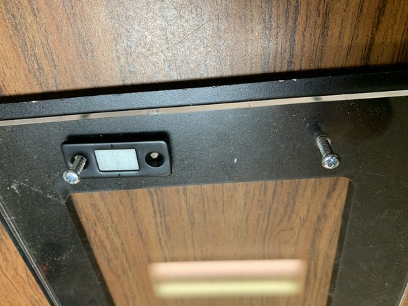 Gently lift the lined up lid assembly from the previous step and line up the handle with the screw holes on the back side. Tighten the screws into the handle as shown in picture 2.