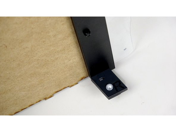 Insert the 20mm bolts though the end holes of the Top Panel (from the finished side).