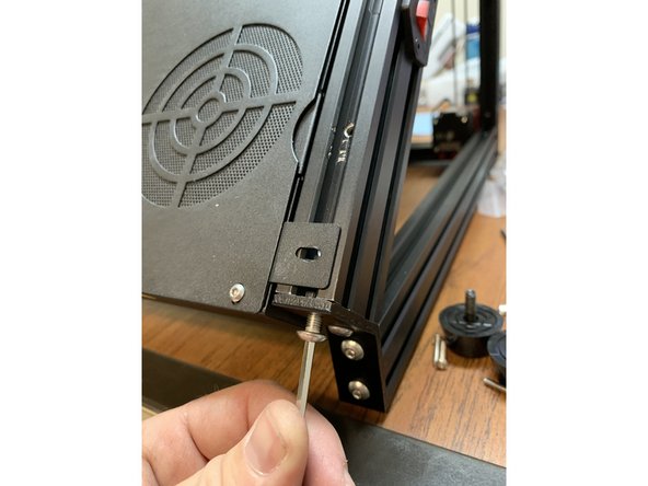 One at a time, remove the two screws holding the angled bracket to the end of the base extrusions.