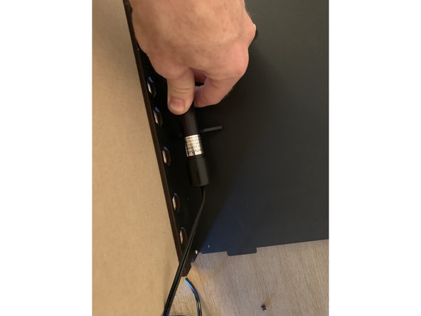 Orient the heater rod so the wire is routing out of the rear corner of the box you removed the knock-out from.