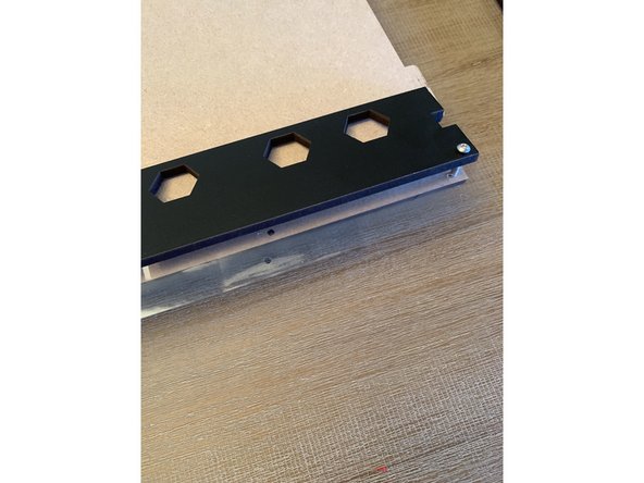 Prior to affixing the vinyl. Press out the pre scored holes with a screw or your included allen key.