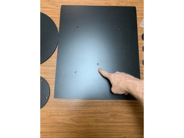 There are multiple holes in the base of the tray for optional turntable configurations. The default configuration uses the center hole thats offset towards the front of the tray. This is normal and makes the turntable more easily accessible when assembled.