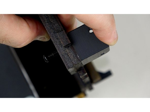 Line up the  Rear Track Guide panel with the bolt holes on the back of the base panel. It will be mounted on the UNFINISHED side of the base panel.