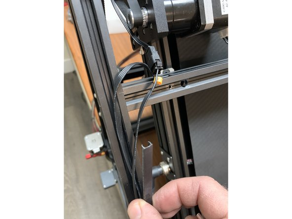 Start by laying your CR-30 on a table as pictured so the control panel and extruder / filament sensor are overhanging the side of the table. This will make it much easier to work on.