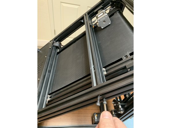 Your goal is to loosen the top beam beneath the belt just enough to slide three slide nuts in to the extrusion.