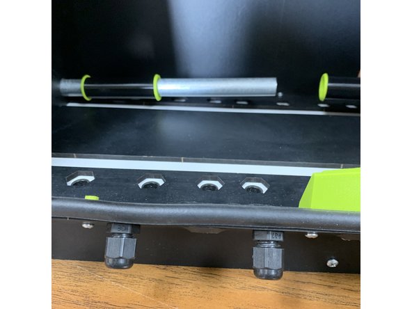 You will notice there are two holes towards the base of the now exposed INNER side panel. TEMPORARILY re-fasten the now exposed INNER side panel to its brackets with the four screws you just removed.