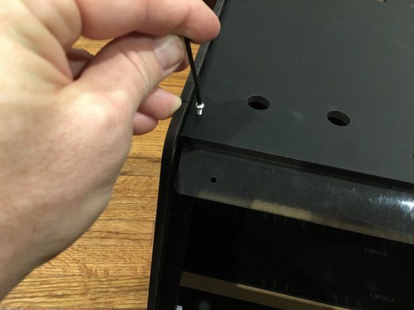The center track guide has a tendency to fall forward as you release it so hold it in place with one hand while you press the side panel onto the top side.