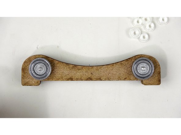 Do the same thing on this side. Bushing, bearing, bushing. One on each bolt.