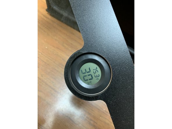 You may need to compress the tabs at the side of the hygrometer slightly and rotate back and forth to press it into the acrylic. It should be a snug fit.