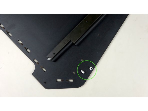 Place two rivnuts into the bottom portion of one the side panels. The rivnuts should come from the unfinished side of the panel.