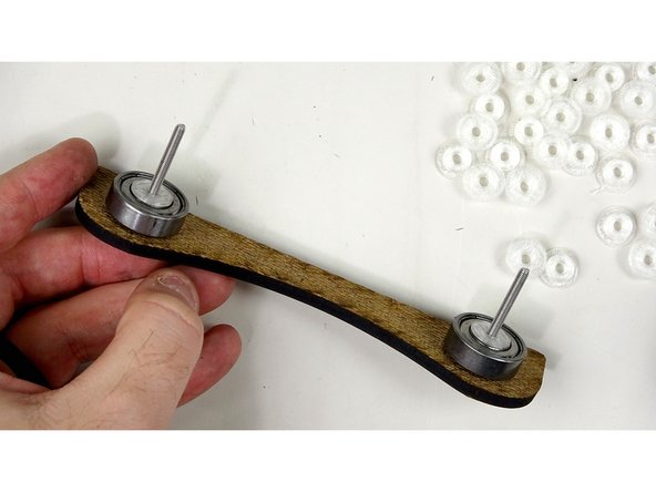 Place another laser cut roller side over the bolts.