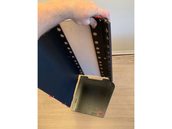 Add a square nut to the top and center holes of one of the mega brackets and align as pictured with the side panel facing you.