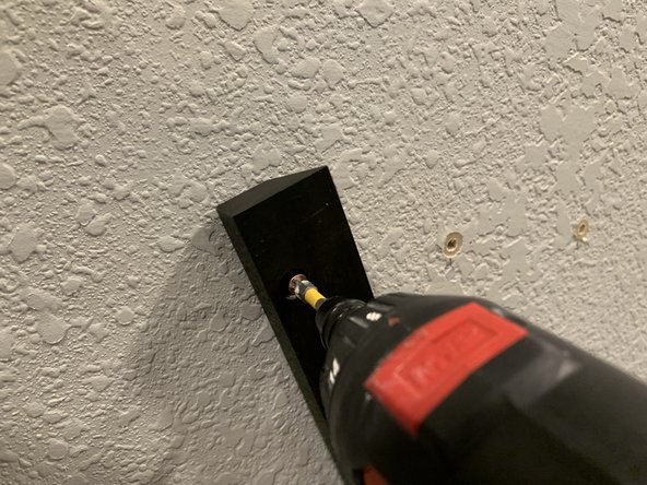 Start by hanging one end of the cleat into the marked hole so that the triangular top of the cleat is pointing straight up.