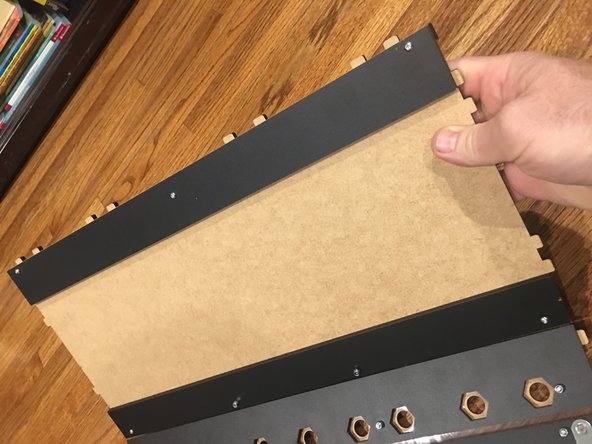 Check to make sure you have the Rear Track Guide on correctly. It should be on the unfinished side of the base panel, with its own finished side facing up. So they should be unfinished side against unfinished side.