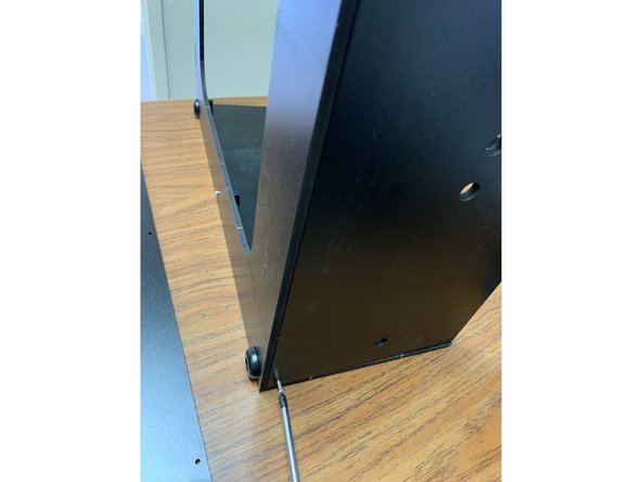 Using two TF screws, fasten the Rear Panel to the base assembly as shown.