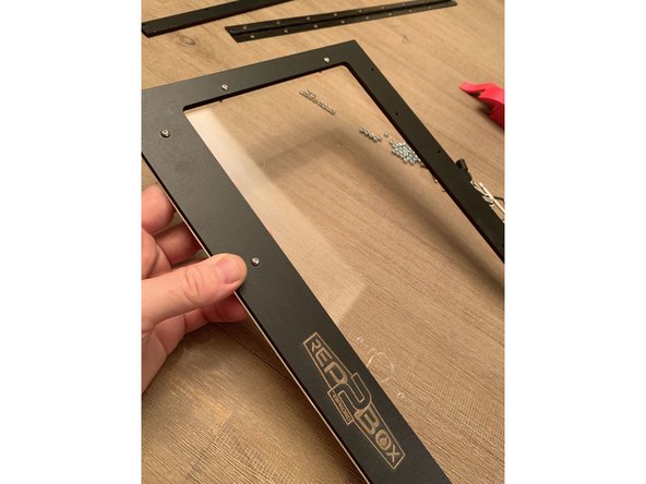 If you purchased your RepBox with the optional Humidity Hunter Kit you will have the version of the lid with the cutout for a hygrometer at the bottom corner. The assembly process for that lid is the exact same and the screws are in the same locations even though it doesn't look exactly like the plain lid pictured here. More Of Those Kit Details Shown Here.