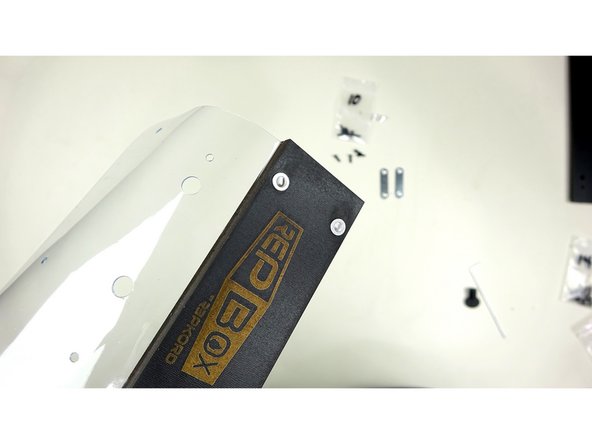 Insert 4 rivnuts (silver tubes in fastener bag) into the large four holes on the ends of the  Face Plates. They should be inserted so the flanged part rests against the FRONT panel.