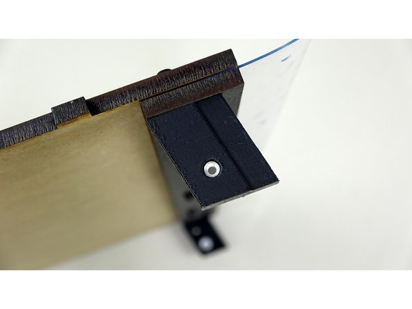 Use the bolts to attach the Trapezoidal Corner Brackets. The embossed letters should be facing INWARD.