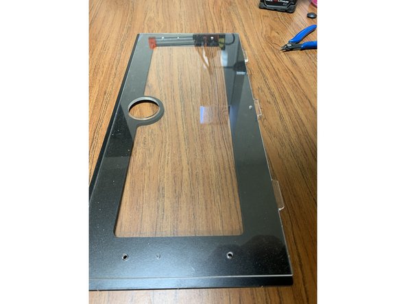 Align the Acrylic Lid (Part 12) with the Faceplate (Part 11) so the holes for the handle line up as shown.