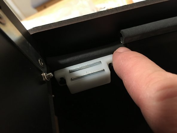 Starting from the center of the faceplate top lip, press the gasket on and move across so that excess is hanging off of both sides of the faceplate