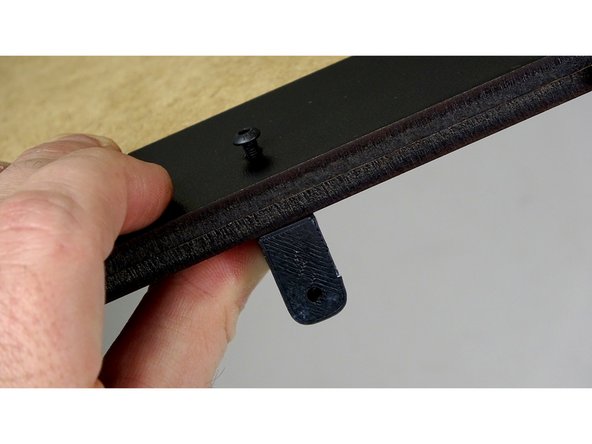 After lining up the Rear Track Guide on the  unfinished side of base panel, insert 16mm bolts through the rear track guide and base panel.