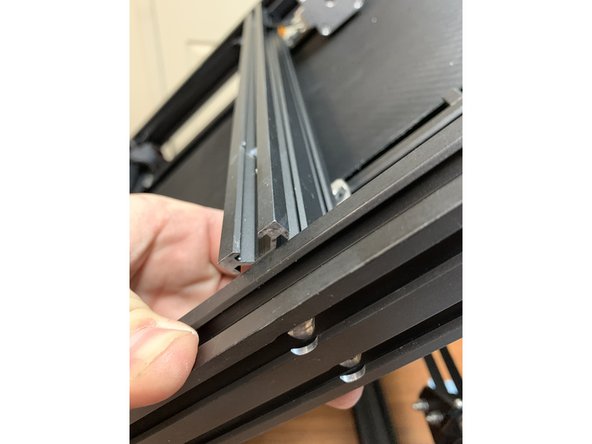 Loosen the screw holding the belt to the top of this crossmember. Doing so will allow you to flex this extrusion upwards enough to add the slide nuts to the extrusion. As shown in pic 3