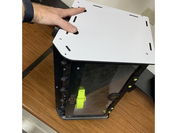 Carefully tip the RepBox back onto its side so that the end without the outer side panel on it is facing upwards. NOTE: Make sure to hold the pipes into their holes while you're doing this so they don't slip out of the opposing support in the bottom side panel.