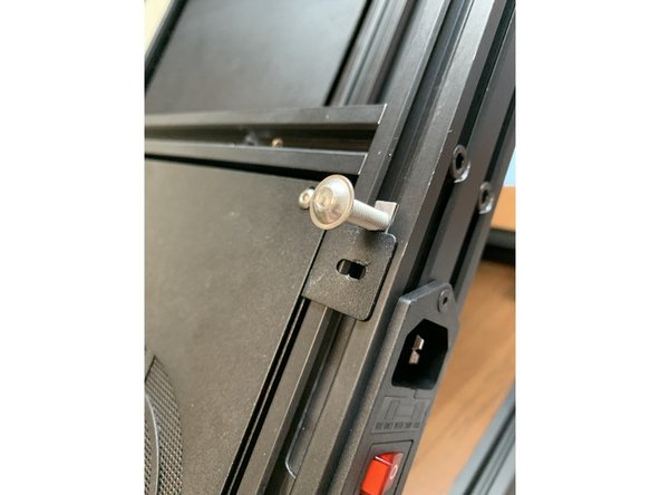 Temporarily add a screw to hold the slide nuts in place above the electronics tray brackets as shown.