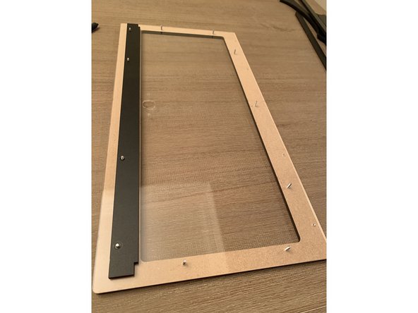 Next you'll be sandwiching the lid acrylic between the faceplate with the engrave on it and the rear lid seal bars as shown in these three photos.