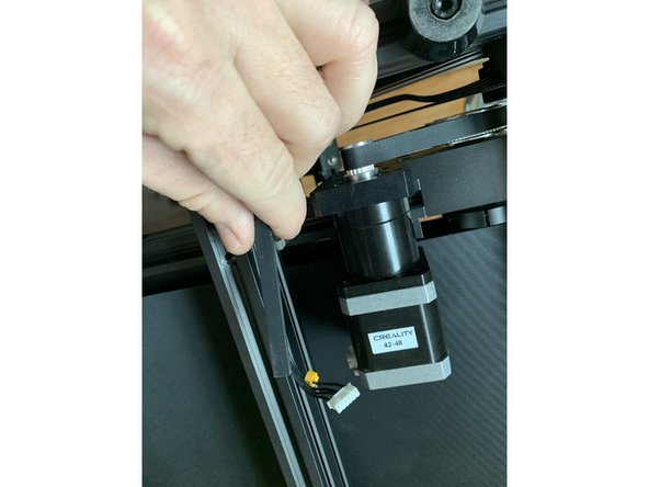 Start by re-routing the wiring for the Z-stepper and endstop from the bottom of the side frame extrusion to the side of it as shown.