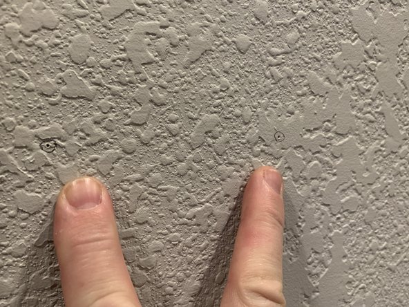 Once you've marked all the holes remove the template and circle your pinholes on the wall with a pencil for better visibility.