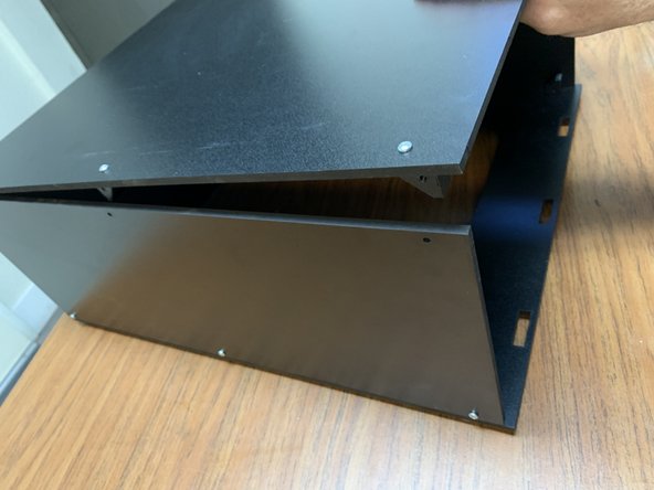 Once you've verified the alignment, fasten the side panels to the Top Panel assembly brackets with a TF screw through each of the open Side Panel holes.