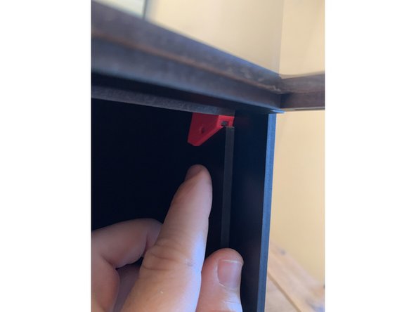 Slide the top of the seal bar around the bracket at the top front corner as shown in pic 3.