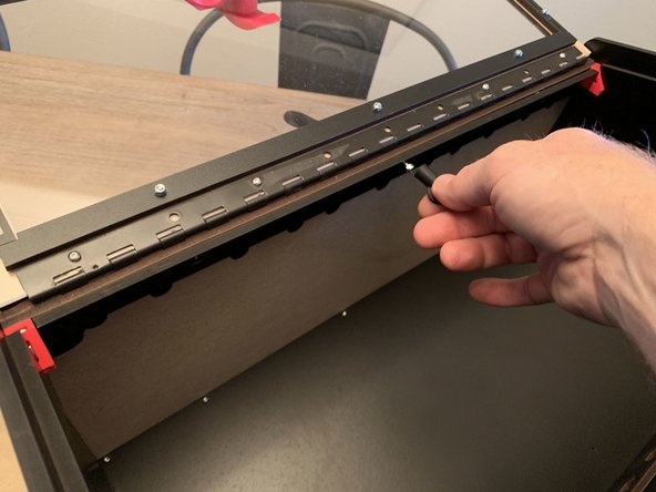 Press the top seal bar on top of the existing top lid clamp and fasten it with the recessed center screw and a nylock.