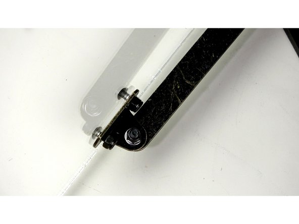 Using 10mm bolts and Nylock nuts, secure the Hinge arms to the Acrylic as shown.