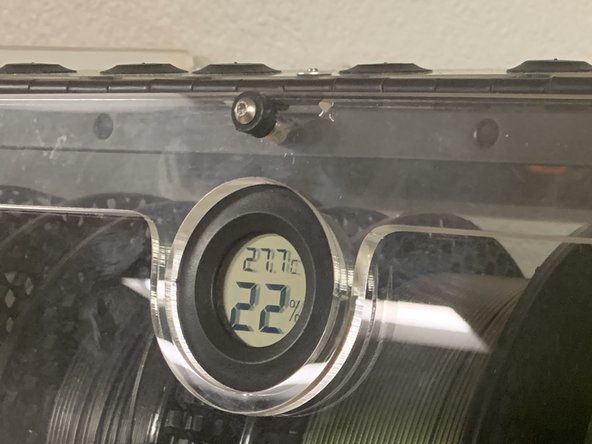 As mentioned in the previous step, newer boxes may have a center hole in your lid and faceplate directly above the &quot;R&quot; Circle or where your Optional Hygrometer may go. This is normal and you fasten it using the same technique as outlined in the previous video for the lid clamps.