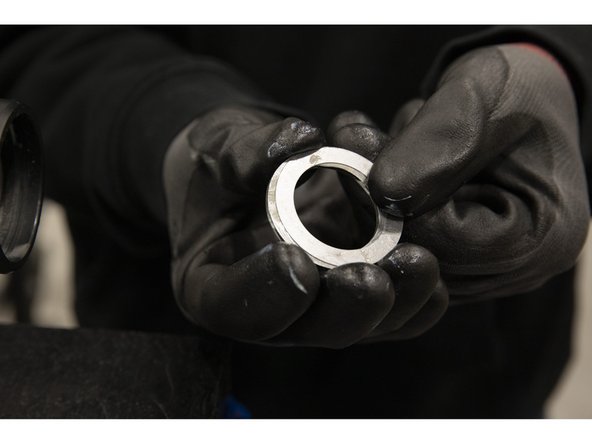 Press the two washers together and the pair inside of the sleeve end, with the shim washer facing inward.