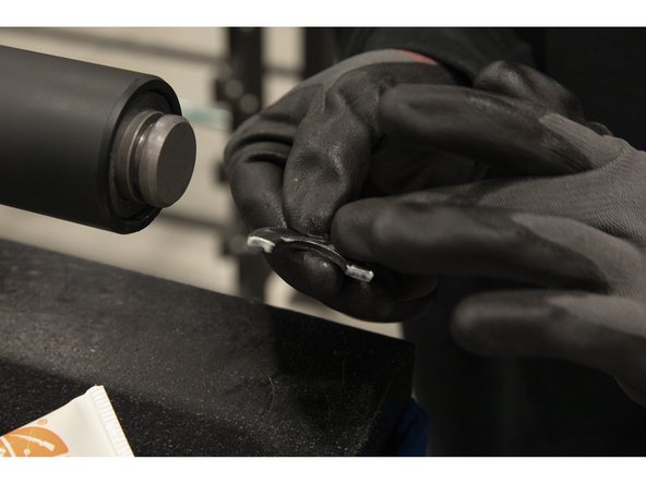 Apply grease on two of the split washers.