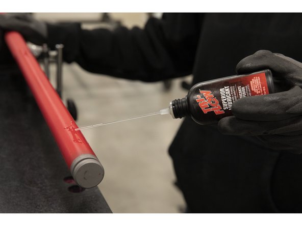 On one end of the bar shaft, apply a 2&quot; line of Triflow on the smooth end next to the groove and a 2&quot; line on the smooth end near the knurling.