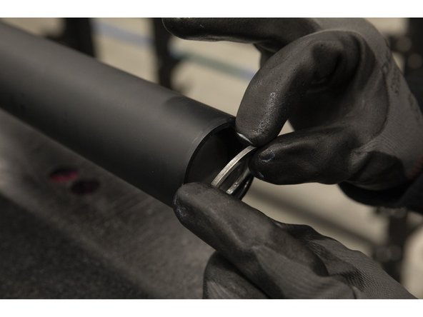 Press the two washers together and the pair inside of the sleeve end, with the shim washer facing inward.